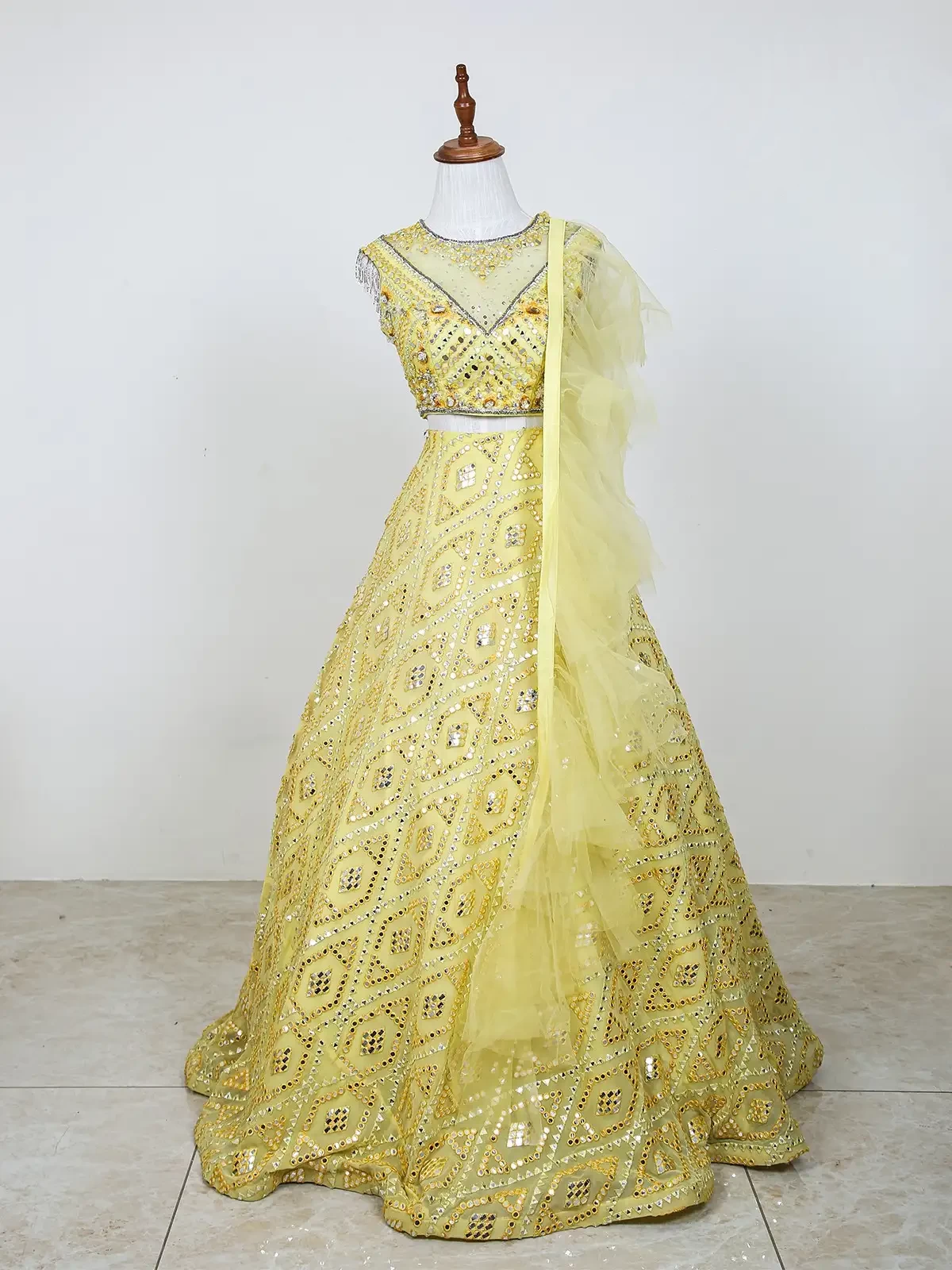 Light Yellow Net Lehenga Embellished with Foil and Thread Work along with Ruffle Dupatta